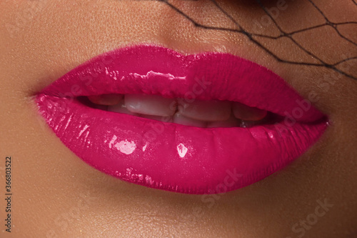 Sexual full lips. Natural gloss of lips and woman's skin. The mouth is open. Increase in lips, cosmetology. Natural lips. Great summer mood and evening make up. Pink lip gloss