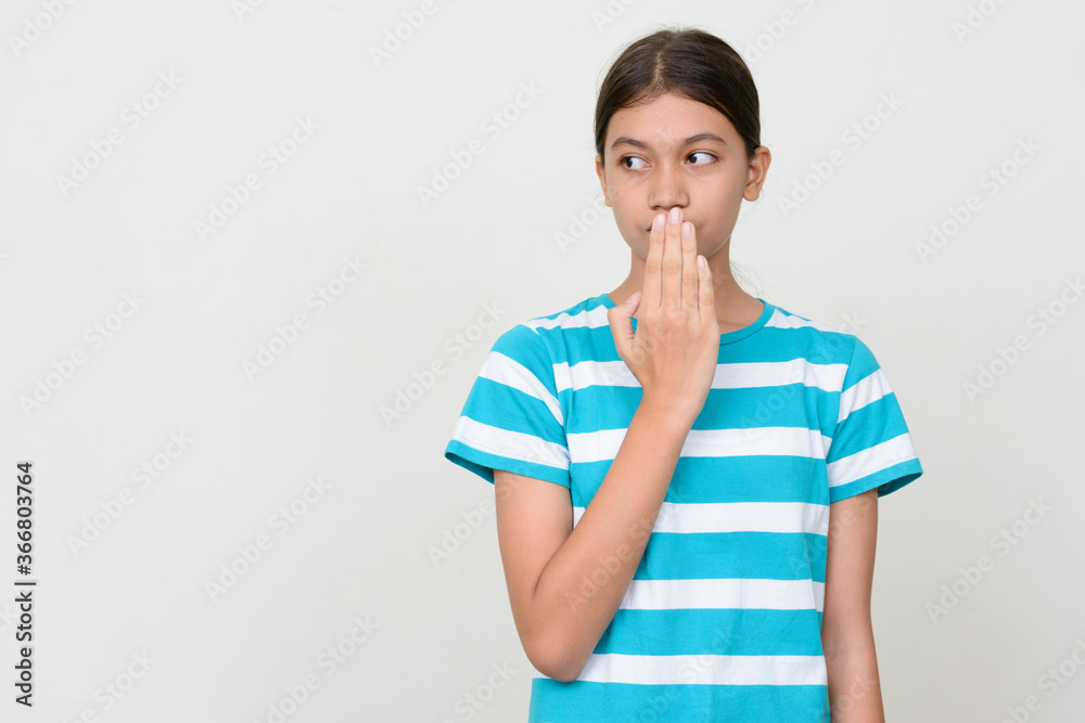 Portrait of young Asian teenage girl against white background Portrait of young Asian teenage girl against white background