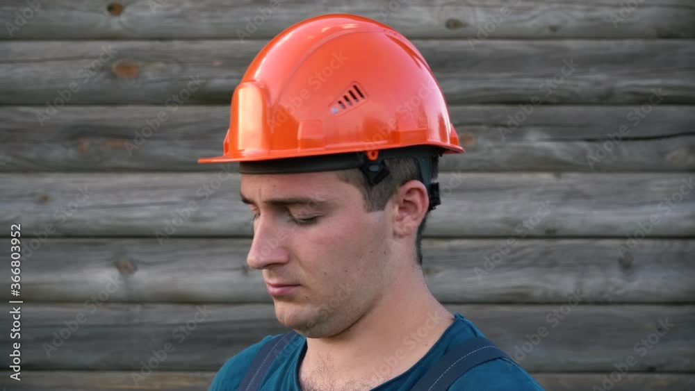 Builder puts on his uniform and prepares for work Builder puts on his uniform and prepares for work