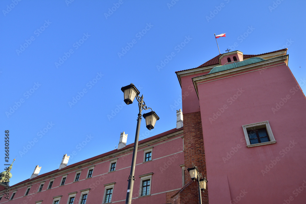 Historic lanterns against the background of the Royal Castle in Warsaw in the light of the rising sun.