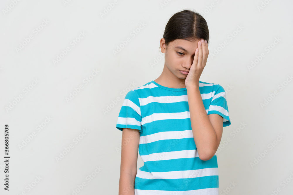 Portrait of young Asian teenage girl against white background Portrait of young Asian teenage girl against white background