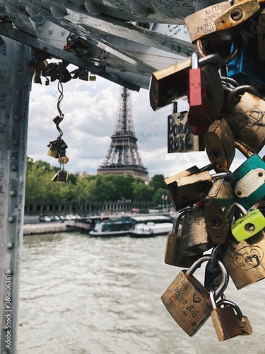 Love. View of the Eiffel Tower through love lock bridge. Paris, France