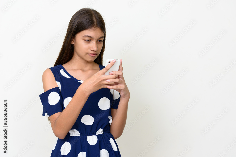 Portrait of young Asian teenage girl against white background Portrait of young Asian teenage girl against white background