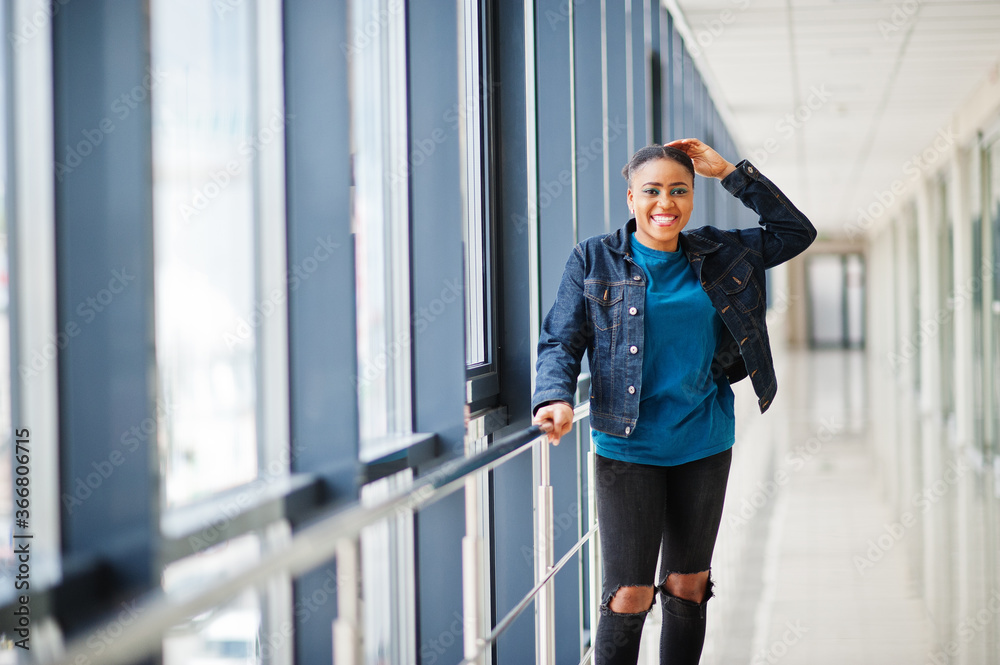 African woman in jeans jacket posed indoor. African woman in jeans jacket posed indoor.