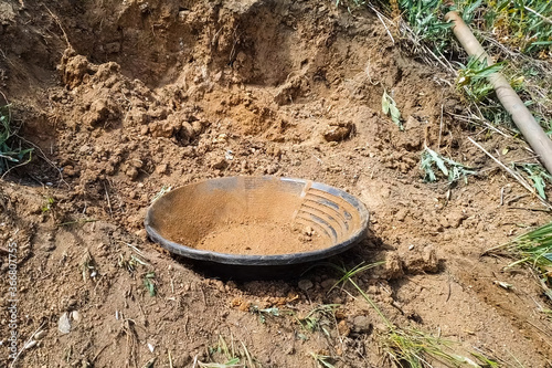 plate for rinsing rock in search of gold.