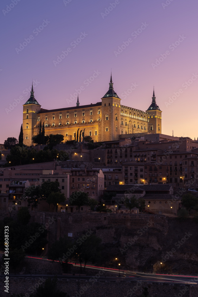 Old city with historic buildings and stone castle on hill against sky during sunset Old city with historic buildings and stone castle on hill against sky during sunset