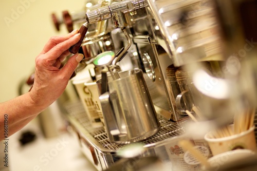 Coffee machine mechanics as a barista prepares a coffee 