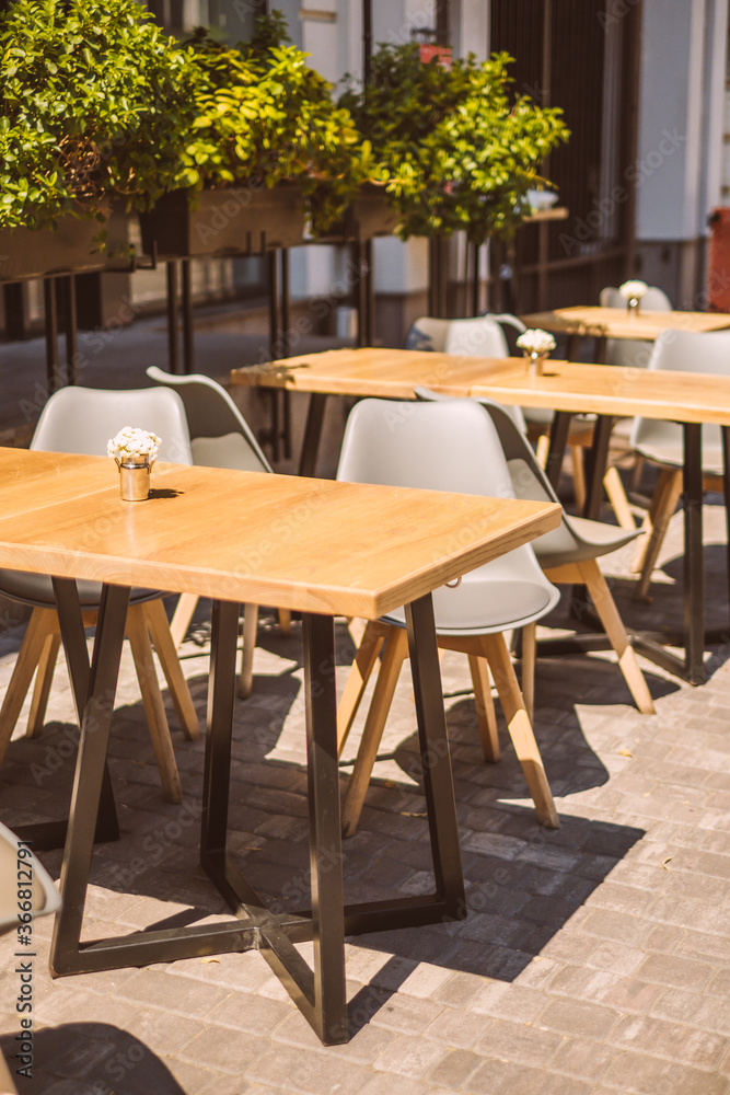 Outdoor cafe terrace with wooden furniture