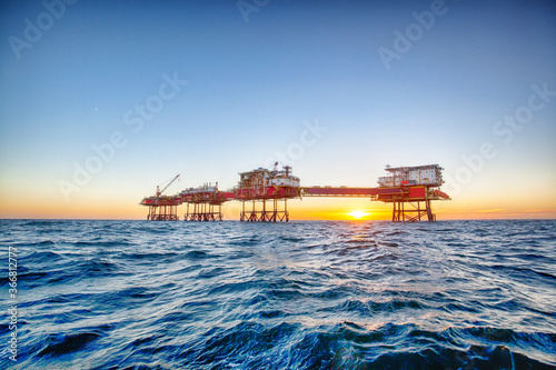 Offshore oil platform at sunset time
