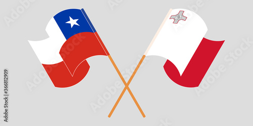 Crossed and waving flags of Malta and Chile