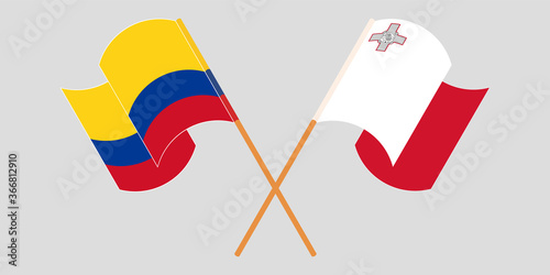 Crossed and waving flags of Malta and Colombia