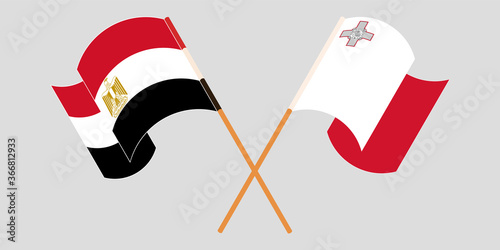 Crossed and waving flags of Malta and Egypt
