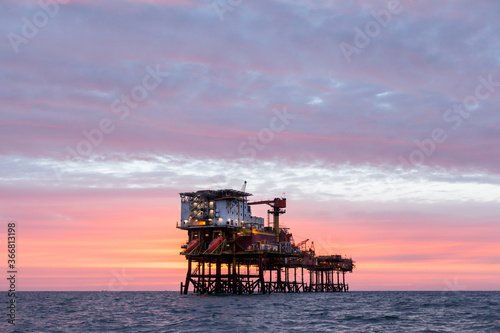 Offshore oil platform at sunset time © Lukasz Z