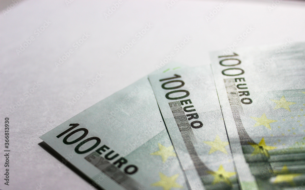 Close-up of 100 Euro banknotes isolated on white background. Currency, financial Close-up of 100 Euro banknotes isolated on white background. Currency, financial