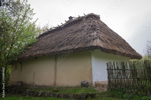 Traditional Ukrainian clay house, hut with a reed roof