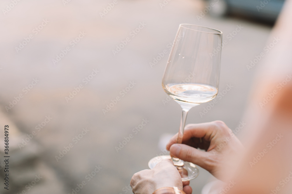 Man holding glass of wine at terrace. Copy space.