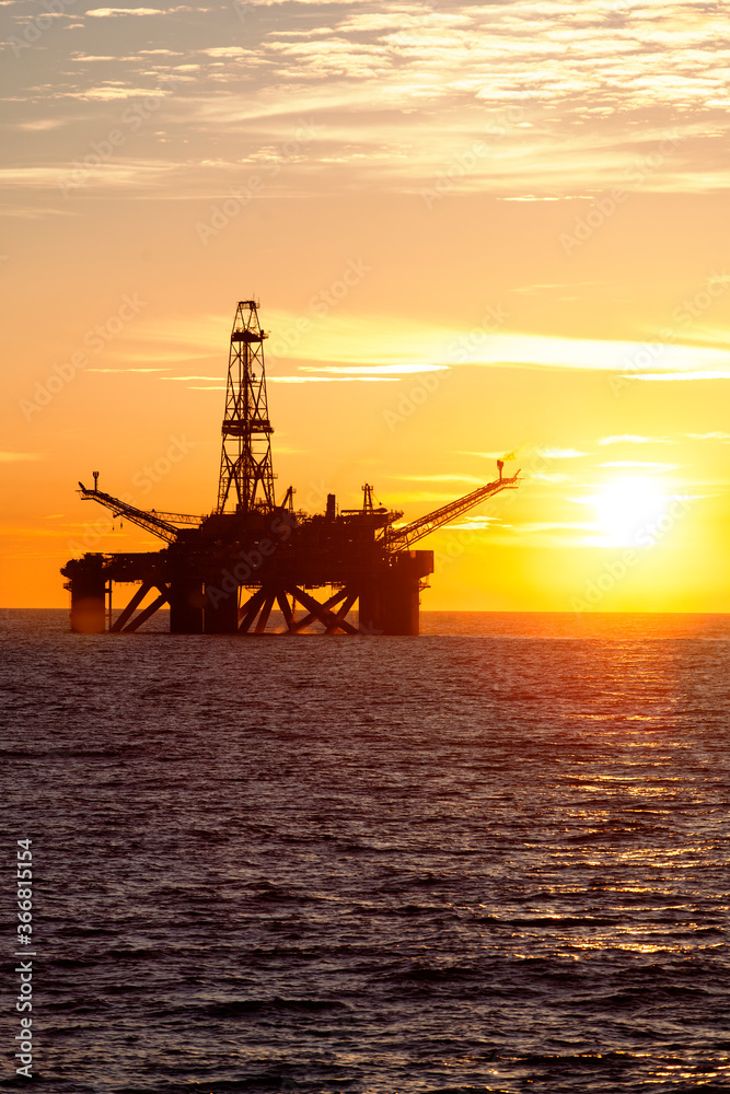 Offshore oil rig at sunset time