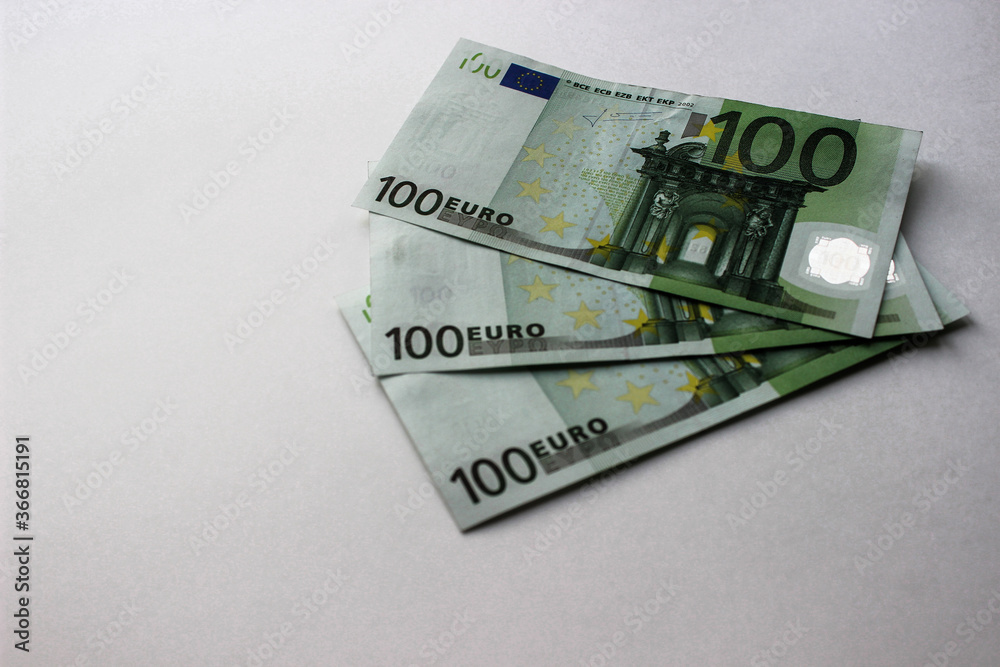 Close-up of 100 Euro banknotes isolated on white background. Currency, financial Close-up of 100 Euro banknotes isolated on white background. Currency, financial