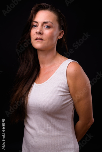 Portrait of mature beautiful woman against black background