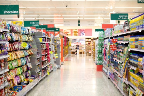 Supermarket aisle filled with a collection of groceries photo