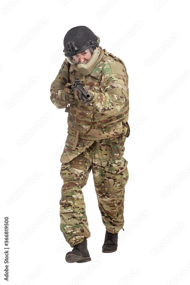 military commando in uniform with a shotgun attacks and aims on a white background, soldier in action military commando in uniform with a shotgun attacks and aims on a white background, soldier in action