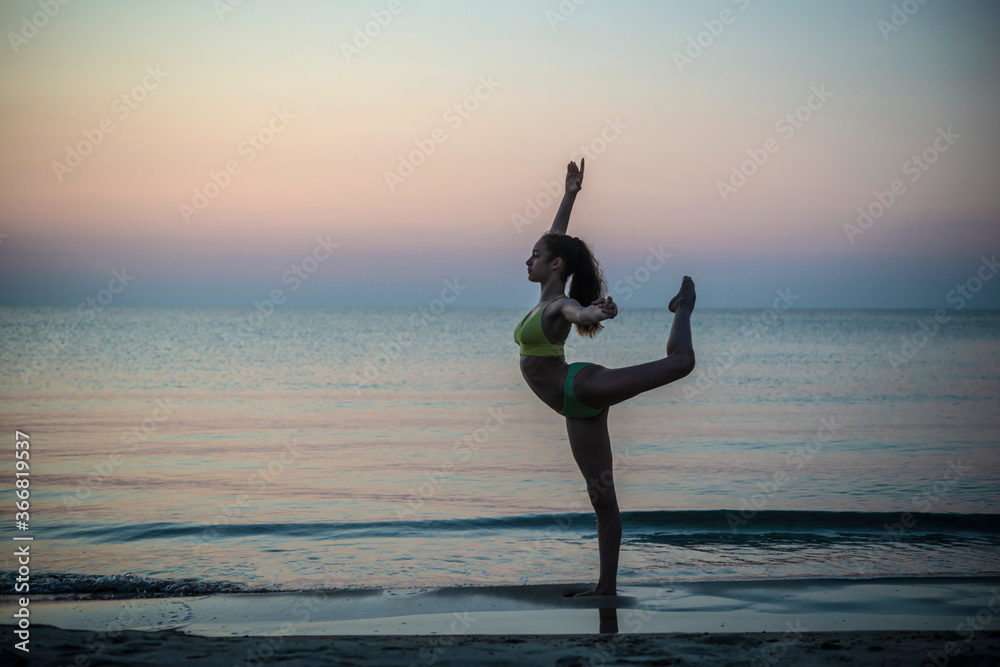 Young girl dancing at sunset