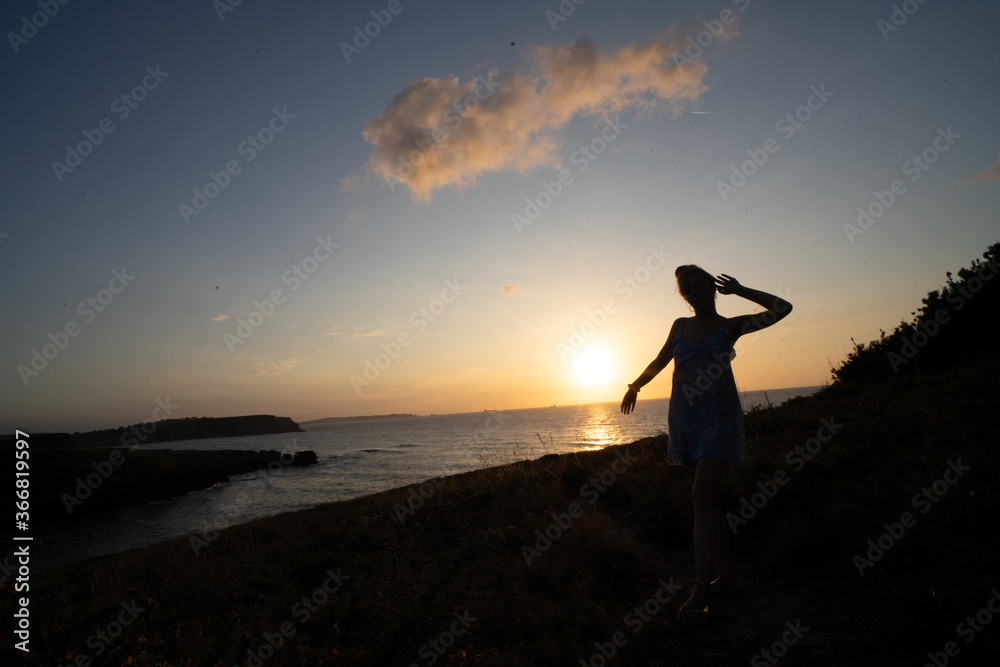 woman enjoying the sunset relaxing with a bow tie