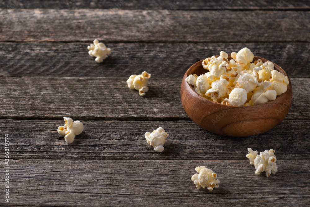 Popcorn in a wooden bowl in rustic style. Wooden bowl with fresh popcorn Popcorn in a wooden bowl in rustic style. Wooden bowl with fresh popcorn