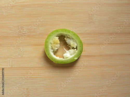 Greenish white color raw round sliced Snake gourd or Trichosanthes cucumerina