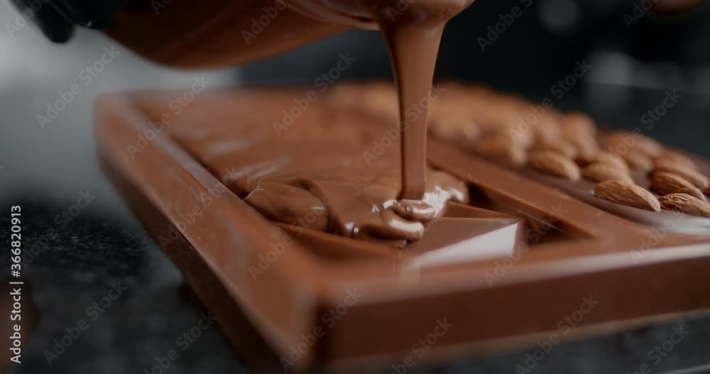Chef confectioner makes chocolate bar - he pours hot melted chocolate to the silicone form, art of handmade chocolate, cooking desserts from chocolate and cocoa, making bars, 4k 120 fps Prores HQ