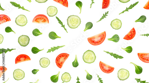 A burst of vegetable slices flying in circles, isolated on white