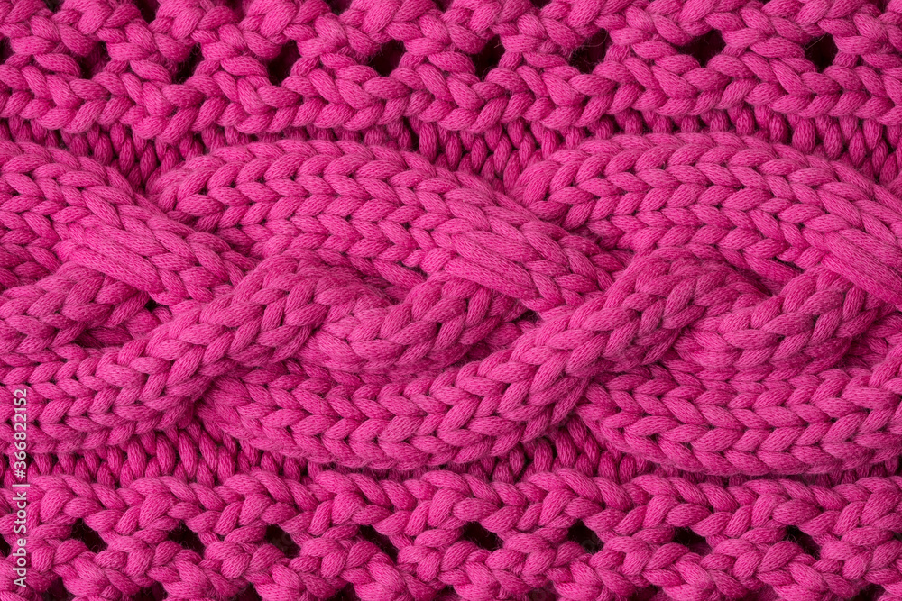 The texture of the knitted with the ornament of purple woolen fabric. Background, pattern, design. The texture of the knitted with the ornament of purple woolen fabric. Background, pattern, design.