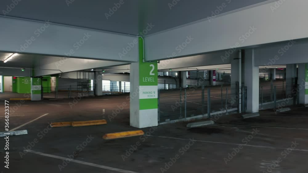 A pandemic outbreak in the USA with empty parking garage building. Industrial interior. Empty parking building during Coronavirus Covid-19 outbreak quarantine. 4K shutdown footage, America A pandemic outbreak in the USA with empty parking garage building. Industrial interior. Empty parking building during Coronavirus Covid-19 outbreak quarantine. 4K shutdown footage, America