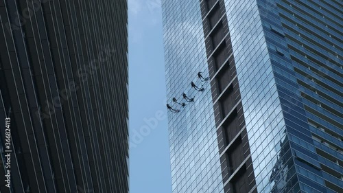 Steeplejacks working on a frontispiece of a skyscraper