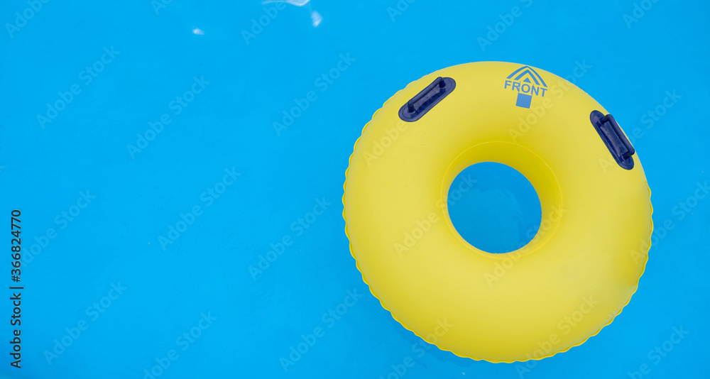 Naklejka premium swimming circle on blue water in a pool with comfortable handles 