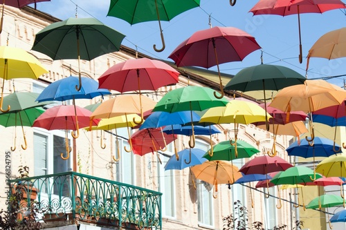 colorful umbrellas on the street with balcony