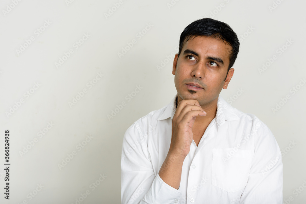 Portrait of handsome Indian businessman against white background Portrait of handsome Indian businessman against white background