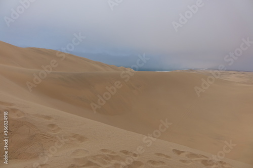 NAMIBIA - SANDWICH HARBOUR - DESERT DUNES AND SEA.