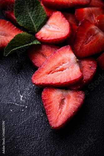 Macro shot of the strawberries cut on the black background