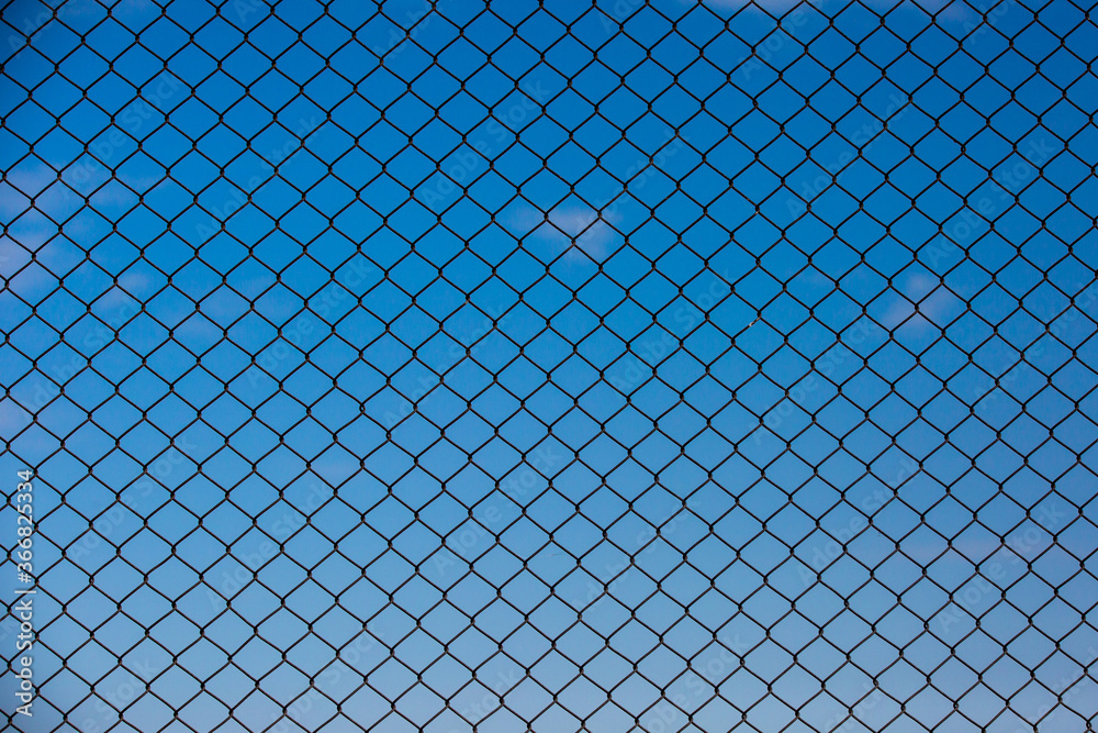 Fototapeta premium Wire fence and blue sky background
