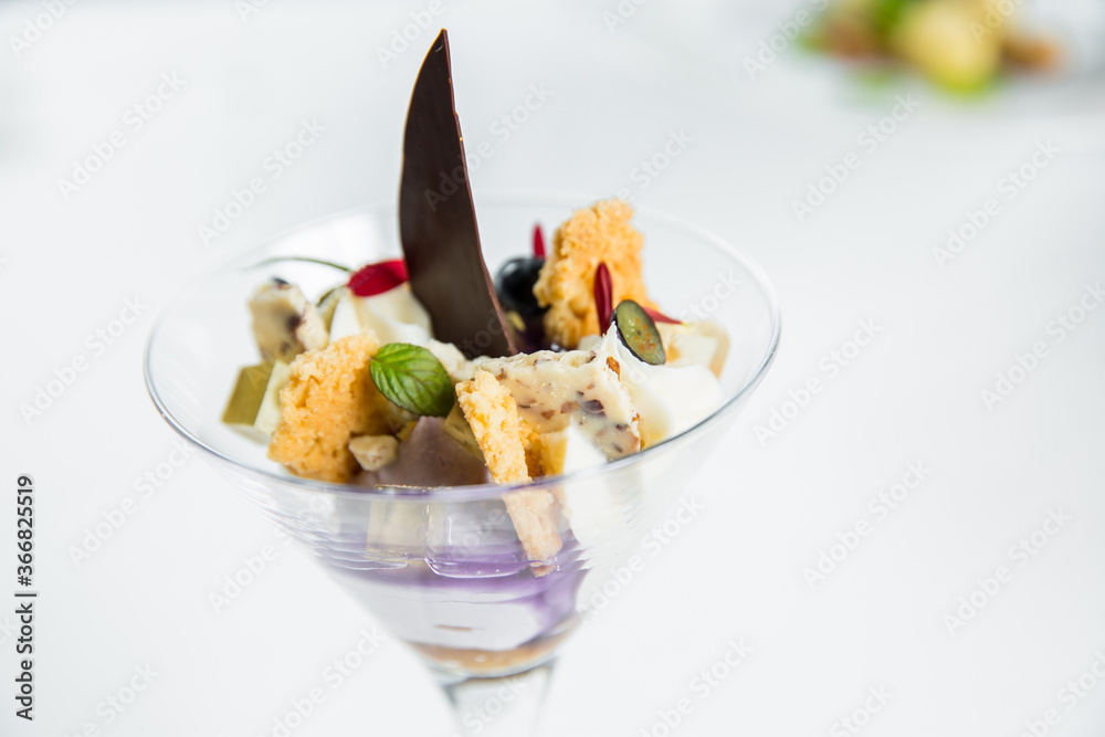 Dessert with biscuits, chocolate and ice cream. Modern cake in a glass