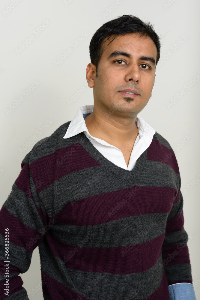 Obraz premium Portrait of handsome Indian man against white background
