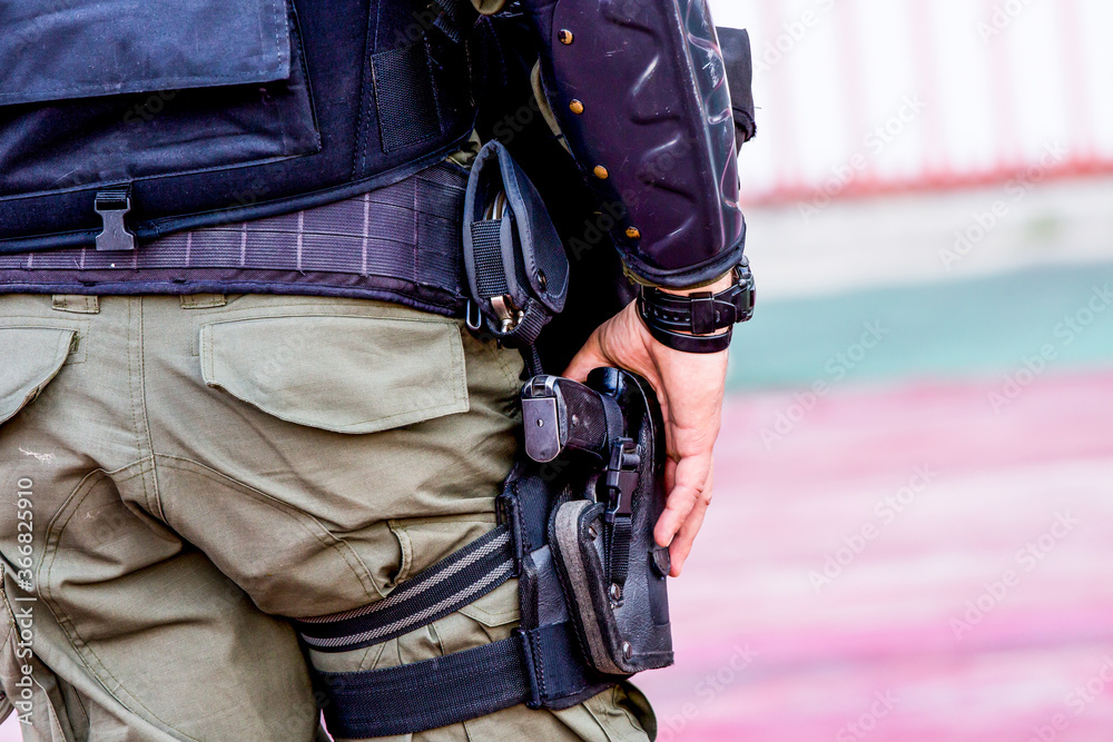 Police force with a gun to maintain order in the area during the rally Police force with a gun to maintain order in the area during the rally