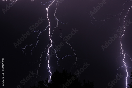 Dual lightning strikes during a desert monsoon storm at night