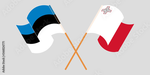 Crossed and waving flags of Malta and Estonia