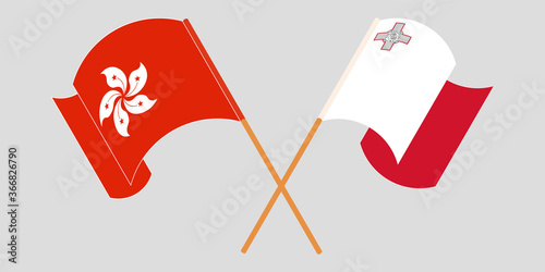 Crossed and waving flags of Malta and Hong Kong