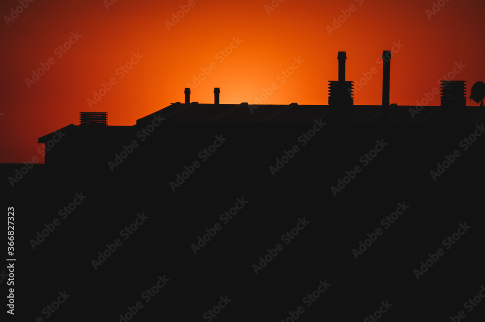 Amazing silhouette view of roof building at warm sunset during spanish summer. Beautiful dusk in Zaragoza on August