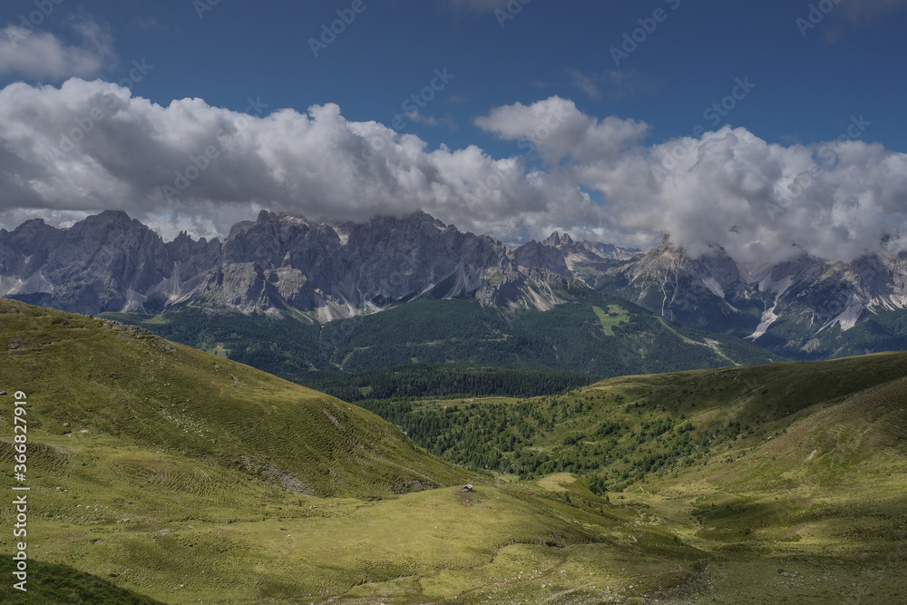 View of Sesto Dolomites massif and Tre Cime di Lavaredo iconic summits in Italy as seen from  Carnic Alps ridge and passes along the Carnic Peace Trail, Cranic Alps Highroute trek, Austria.