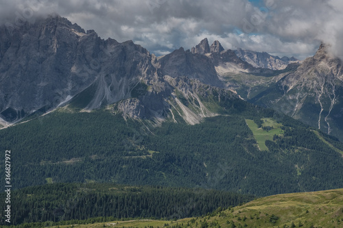 View of Sesto Dolomites massif and Tre Cime di Lavaredo iconic summits in Italy as seen from Carnic Alps ridge and passes along the Carnic Peace Trail, Cranic Alps Highroute trek, Austria.