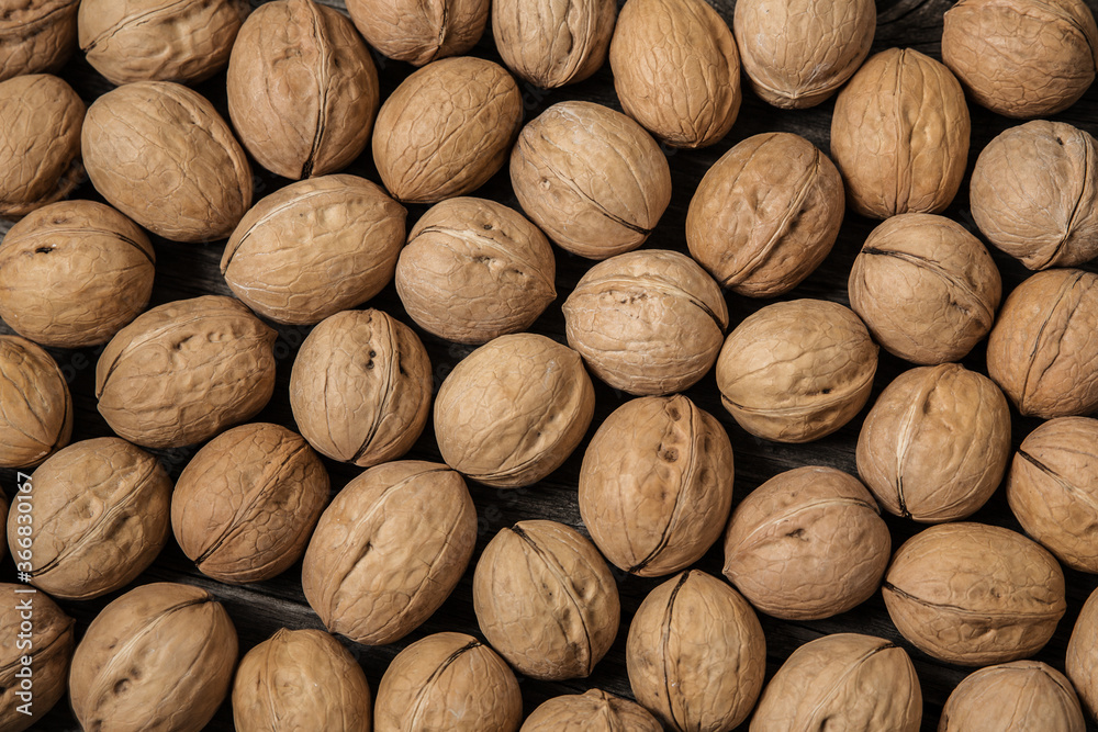 A lot of walnuts, Juglans regia as background texture closeup, top view A lot of walnuts, Juglans regia as background texture closeup, top view